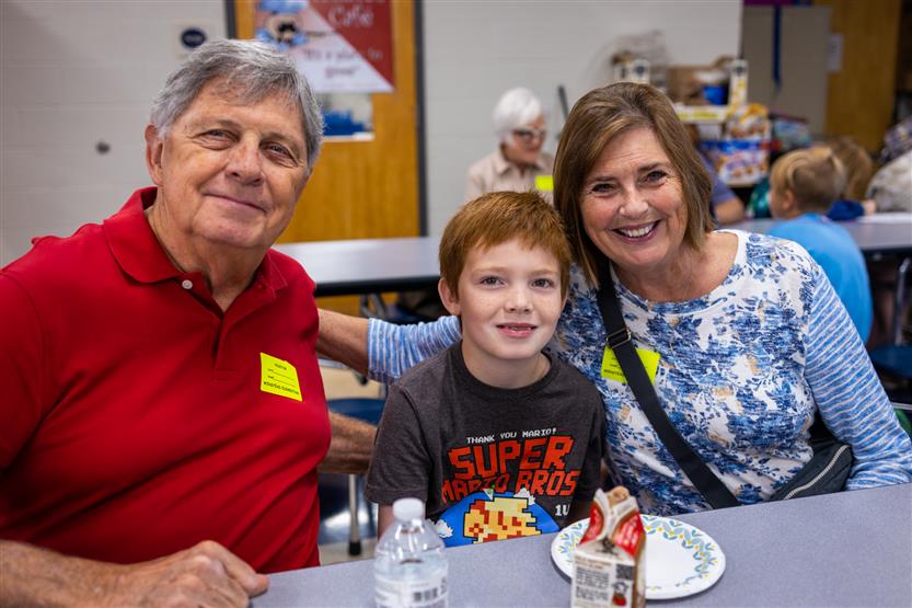 A family smiles at Winstead Elementary's Grandparents Breakfast